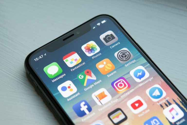 Building a website and app with a news API, phone showing app screens