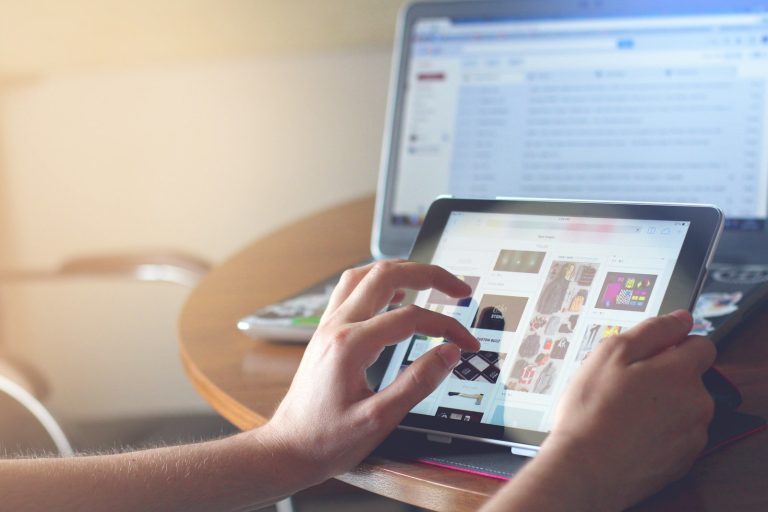 Person reading news on iPad — best news API 2026 comparison guide